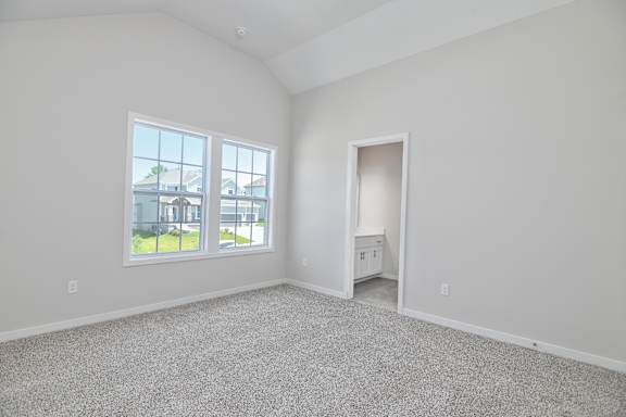 A large empty room with a doorway leading to another room.