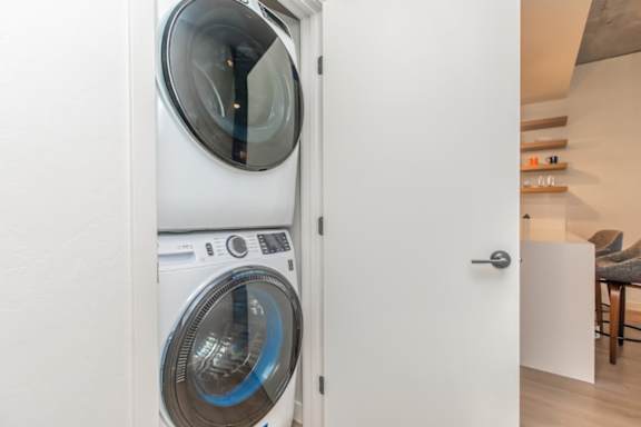 A white washing machine is in a doorway.