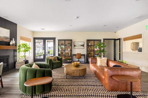 a living room with leather furniture and a fireplace