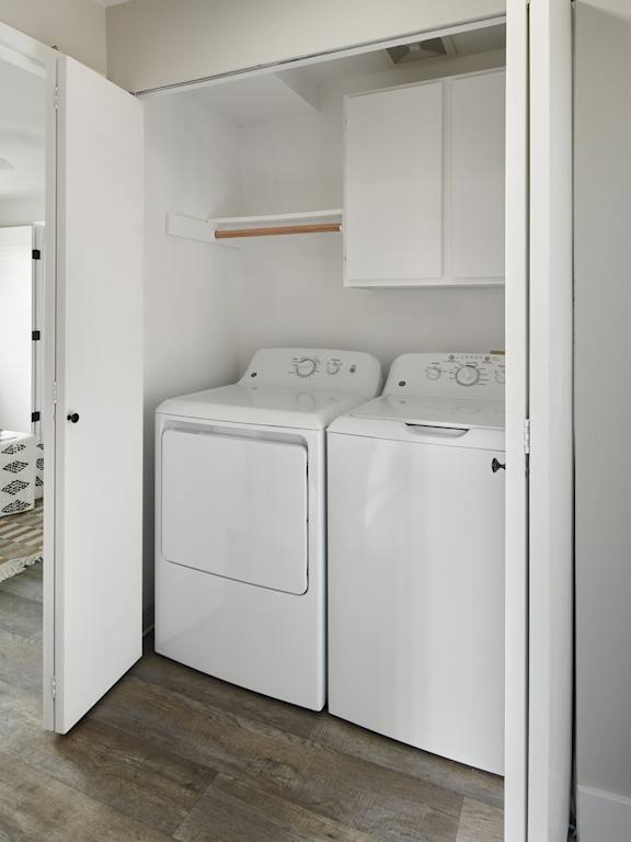 A white washing machine and dryer in a small laundry room.