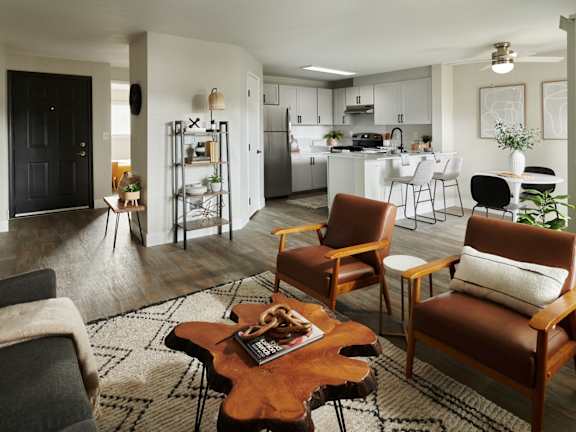 a living room and kitchen with a table and chairs