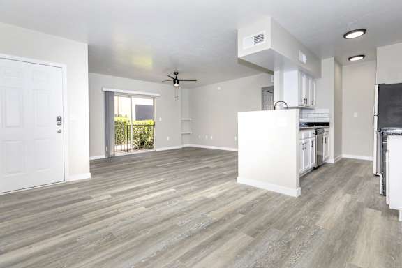 A spacious kitchen with a white cabinet and a ceiling fan.