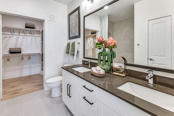 A bathroom with a white toilet and a white sink.
