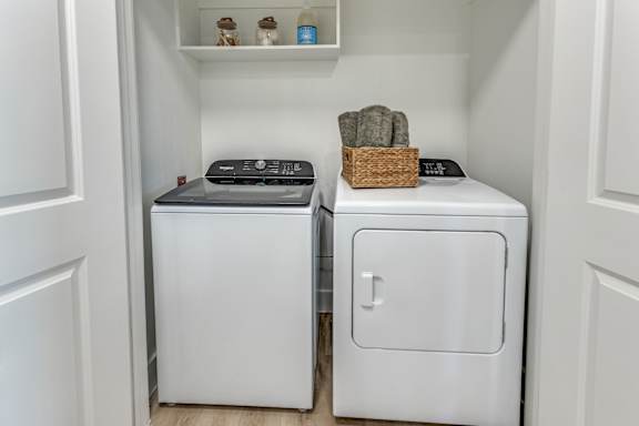 A small laundry room with a washer and dryer.