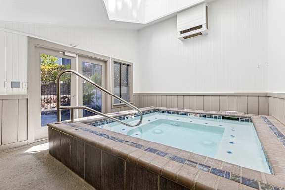 A small indoor pool with a brown tile border.
