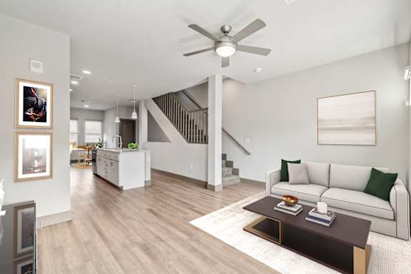 A living room with a white couch and a coffee table.