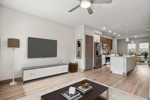 A modern living room with a flat screen TV mounted on the wall.
