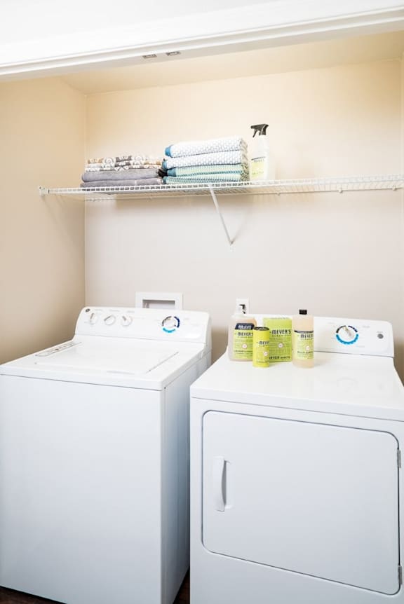 A white washing machine and dryer in a laundry room.