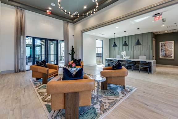 A large room with a couch, chairs, and a table.