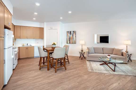 A modern kitchen with a dining table and chairs.