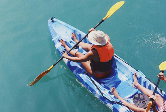 a group of people kayaking in the water