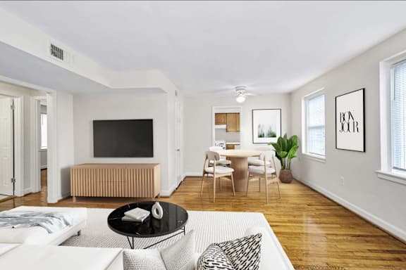 A living room with a white couch and a television.