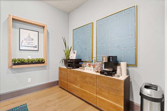 A reception area with a wooden desk and a framed picture on the wall.