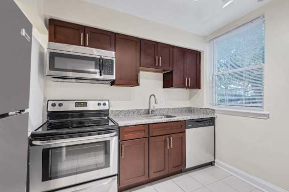 A kitchen with a stove, microwave, and dishwasher.