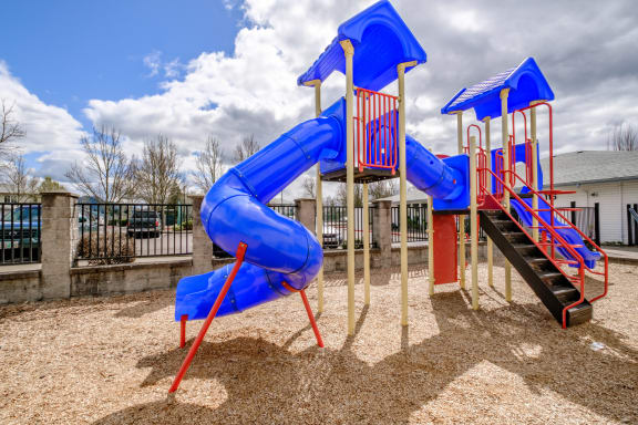 a playground with a blue and red slide