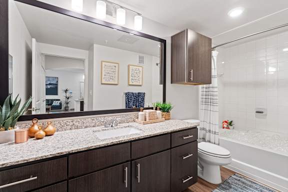 A bathroom with a sink, toilet, and bathtub.