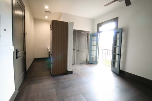 A room with a brown wardrobe and a white door.