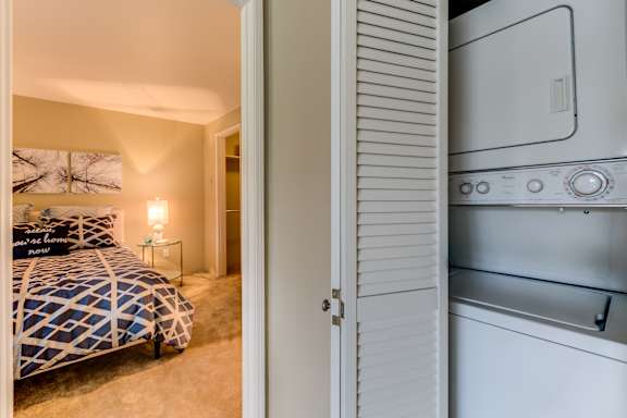 A bedroom with a bed and a white oven in the same room.