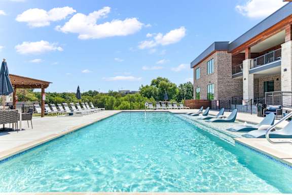 Northside at the Woodlands Apartments in Garland, Texas Pool with Lounge Chairs