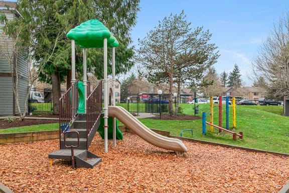 a playground with a slide and monkey bars