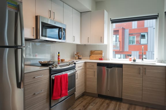 a kitchen with stainless steel appliances and a window at Wilcox, Seattle, Washington, 98107
