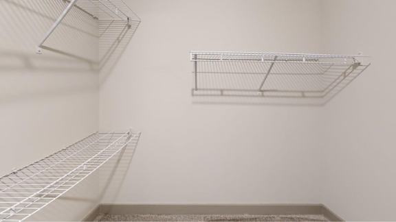 Empty wire shelving in a room.