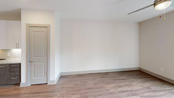 A 3D floor plan of a small apartment with a living room, kitchen, and bathroom.