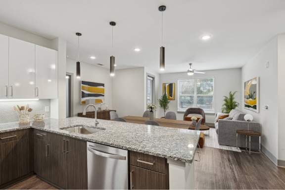 A modern kitchen with a granite countertop and stainless steel appliances.