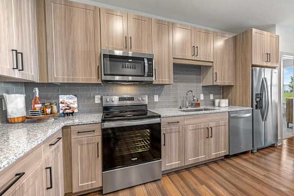 A kitchen with wooden cabinets and stainless steel appliances.