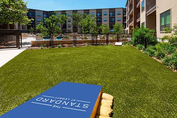 A blue book with the word "CONSERVATORY" on it is placed on a lawn.