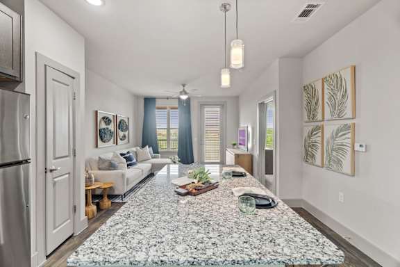 A modern living room with a large rug in the center.