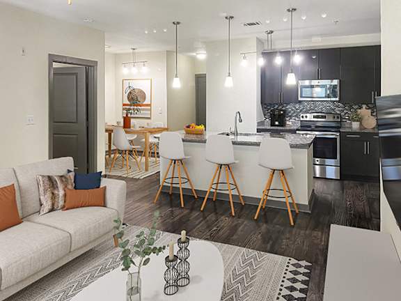 a living room with a kitchen and a dining room