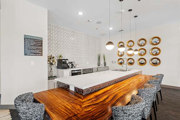 A modern dining room with a wooden table and chairs.