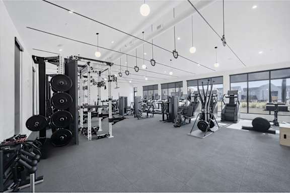 A spacious gym with a variety of equipment.