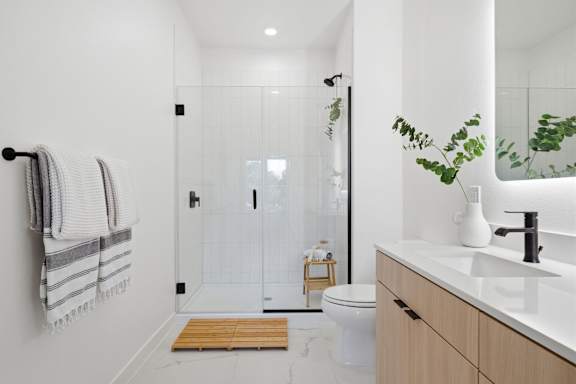 A bathroom with a toilet, sink, and shower.