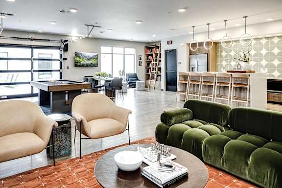 A living room with a green couch and a coffee table.