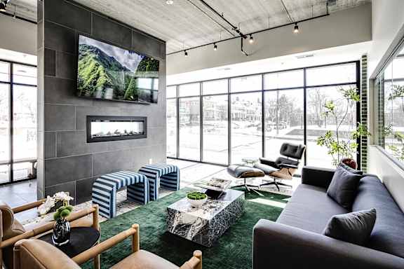 A modern living room with a flat screen TV mounted on the wall.