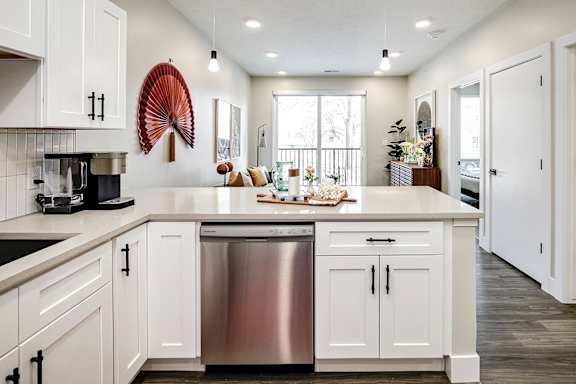 A modern kitchen with white cabinets and a large island.