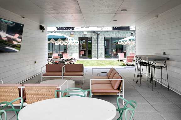 A patio with a white table and chairs.