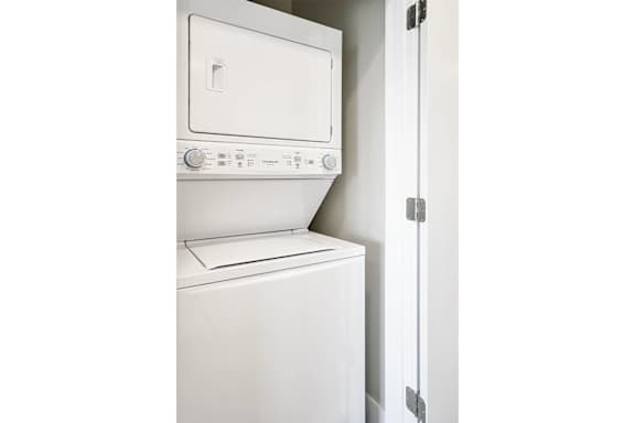 A white washing machine in a laundry room.