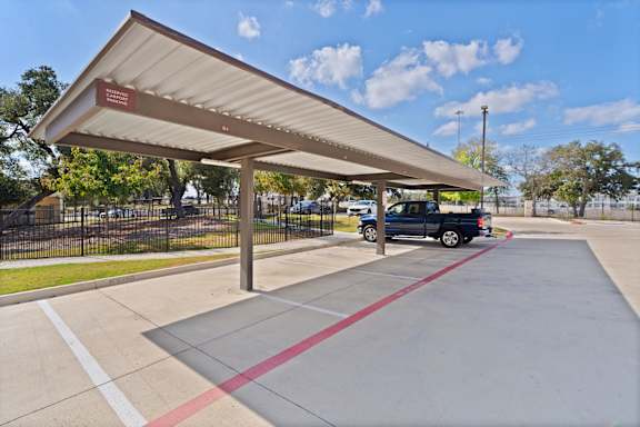 A covered parking area with a sign that says "Parking Only".