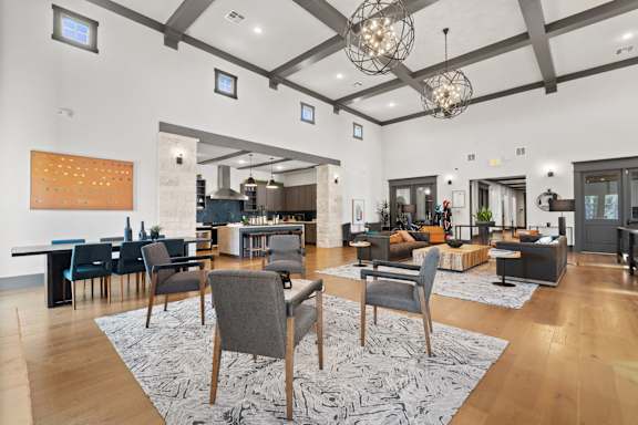 A modern living room with a dining area and kitchen in the background.