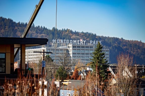 a city with a building and mountains in the background