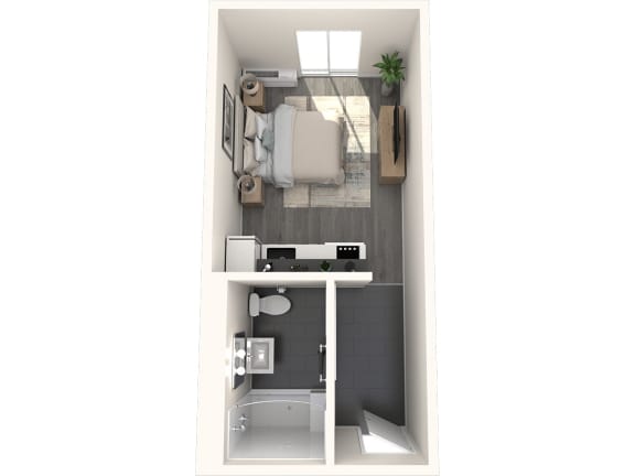 a bedroom with a bed and a desk in a small room