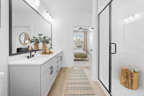 A bathroom with a white sink and a mirror above it.