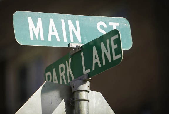 a street sign on top of a stop sign