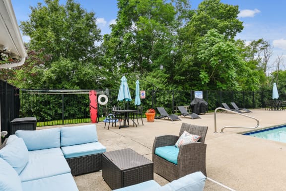 Backyard with a pool and lounge chairs and umbrellas