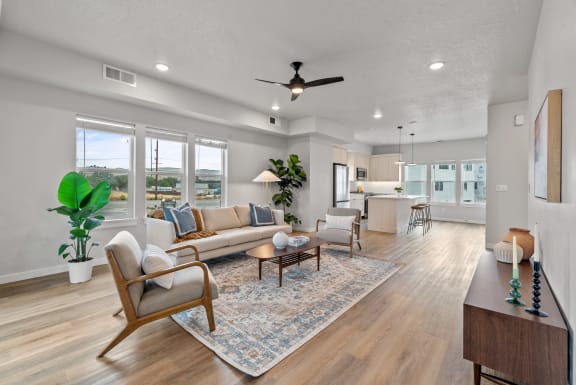 a living room with a couch and chairs and a ceiling fan&#xA0;at Alpine Landing Townhomes, Garden City, 83714