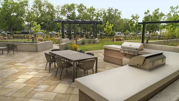 a patio with a grill and a table with chairs at Cycle Apartments, Colorado, 80525