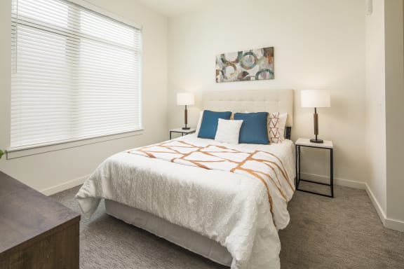 a bedroom with a bed and a large window